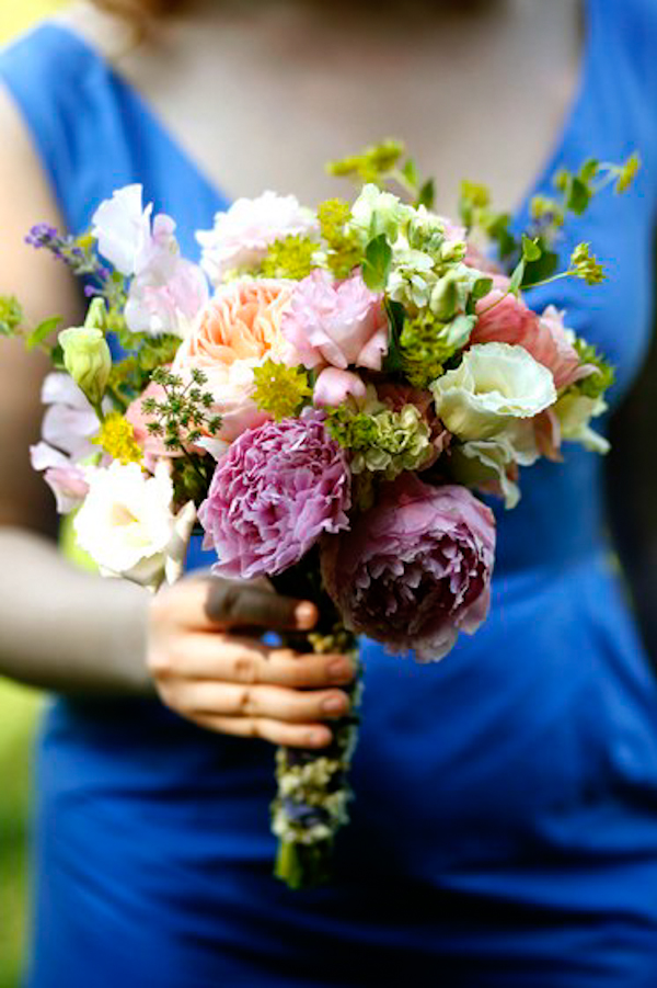 bridesmaid in blue holds assorted bouquet - charming Hudson Valley NY wedding photo by top New York wedding photographers Belathee Photography